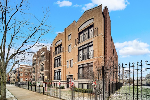 view of building exterior with fence