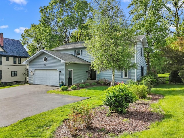 525 W Jackson St, Woodstock, IL 60098 - view of front of home with asphalt driveway, a garage, and a front yard