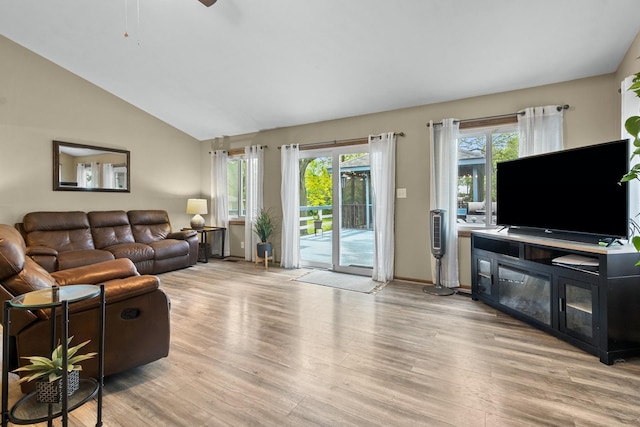 525 W Jackson St, Woodstock, IL 60098 - living area with wood finished floors, lofted ceiling, baseboards, and ceiling fan
