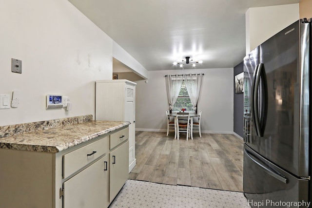 2007 Oak Dr, Mchenry, IL 60050 - kitchen featuring freestanding refrigerator, baseboards, light countertops, and light wood finished floors