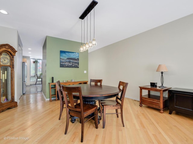 dining area with light wood-style floors and recessed lighting