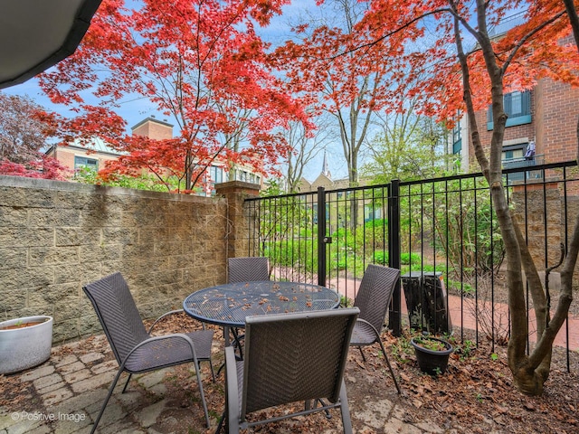 view of patio with fence and outdoor dining area