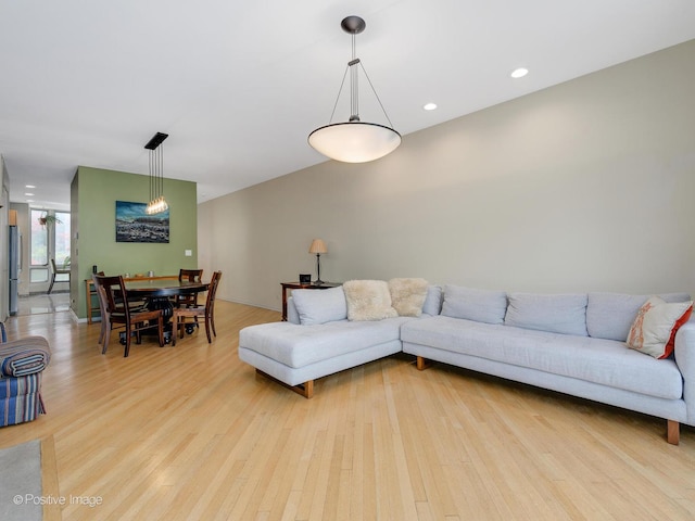 living room with light wood-type flooring and recessed lighting