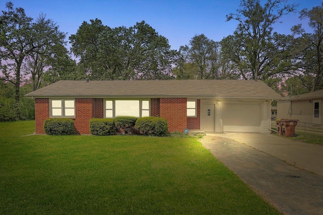 28 Liberty Blvd, Machesney Park, IL 61115 - ranch-style home featuring an attached garage, concrete driveway, a front lawn, and brick siding