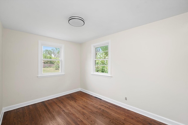 28 Liberty Blvd, Machesney Park, IL 61115 - spare room with baseboards, healthy amount of natural light, and dark wood-type flooring