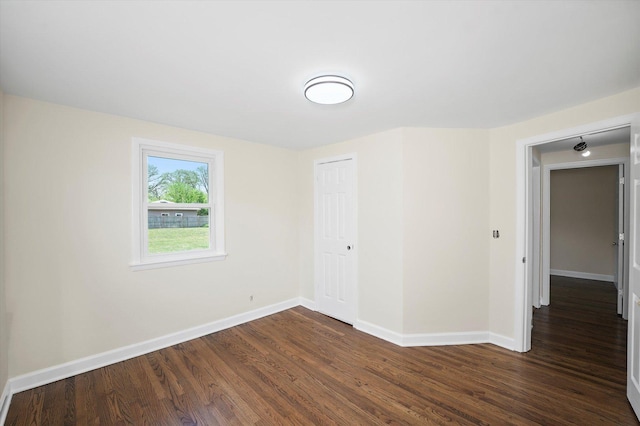 28 Liberty Blvd, Machesney Park, IL 61115 - empty room featuring dark wood-style floors and baseboards