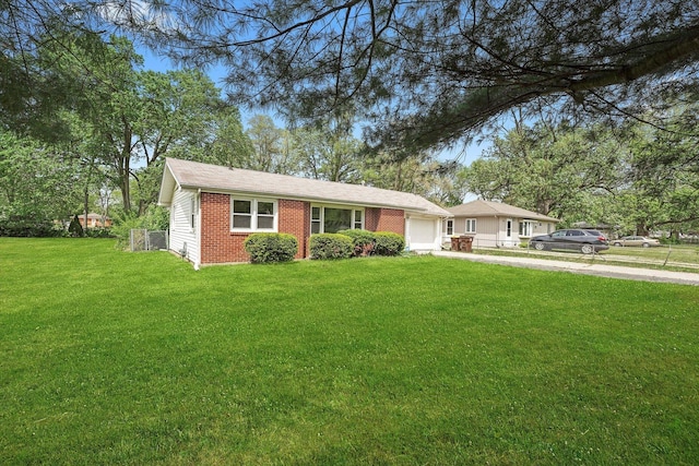 28 Liberty Blvd, Machesney Park, IL 61115 - ranch-style house with driveway, a garage, a front yard, and brick siding