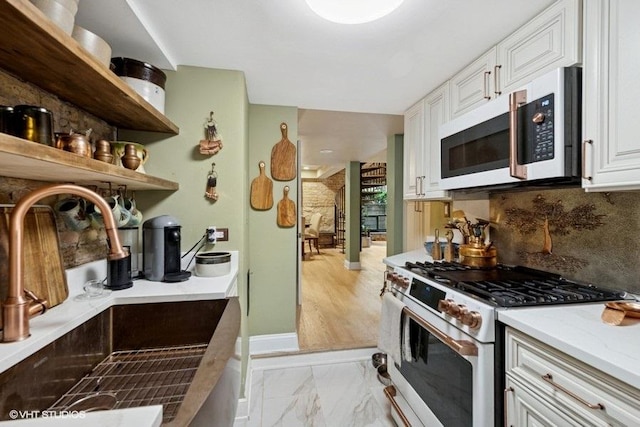 540 W Belden Ave Unit 1A, Chicago, IL 60614 - kitchen with white appliances, a sink, decorative backsplash, white cabinets, and light marble finish flooring
