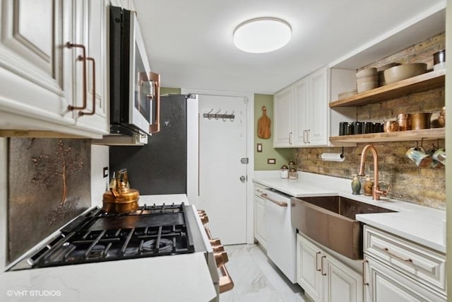 540 W Belden Ave Unit 1A, Chicago, IL 60614 - kitchen with stainless steel microwave, a sink, dishwasher, backsplash, and light marble finish flooring