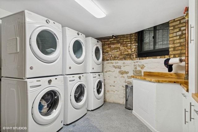 540 W Belden Ave Unit 1A, Chicago, IL 60614 - shared laundry featuring estacked washer and dryer, washer and dryer, and brick wall