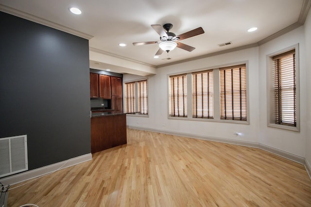 unfurnished living room with ornamental molding, ceiling fan, baseboards, light wood finished floors, and recessed lighting