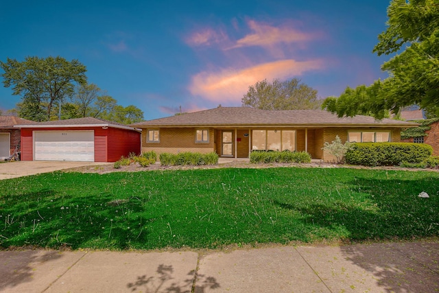 805 Grand Blvd, Joliet, IL 60436 - ranch-style home with a lawn, a garage, brick siding, and concrete driveway