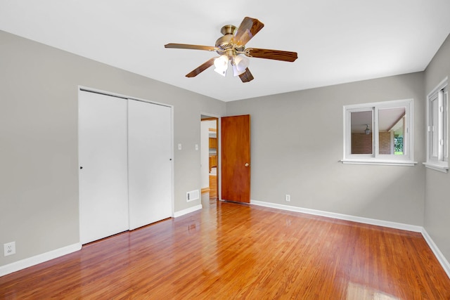 805 Grand Blvd, Joliet, IL 60436 - unfurnished bedroom featuring light wood-style floors, baseboards, a closet, and a ceiling fan