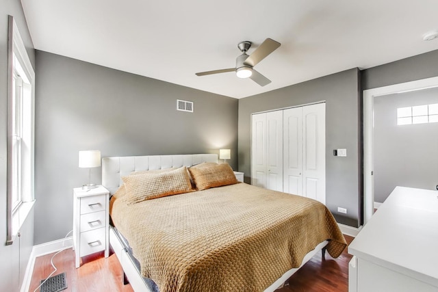 1524 Cleveland St, Evanston, IL 60202 - bedroom featuring a closet, baseboards, wood finished floors, and a ceiling fan