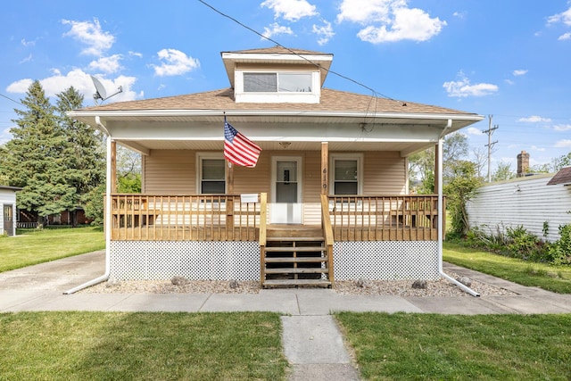 610 Clinton St, Lockport, IL 60441 - bungalow with a porch, a shingled roof, and a front lawn