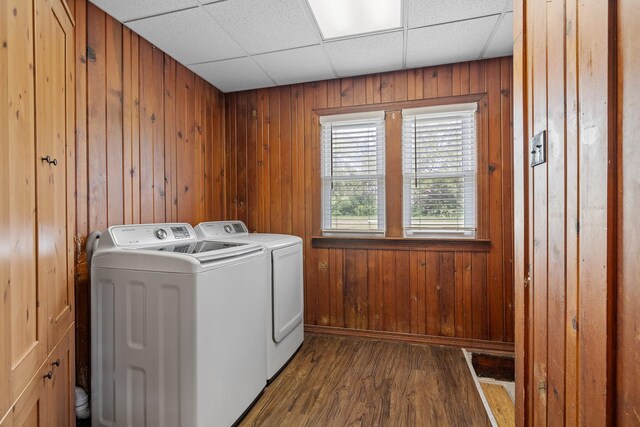 610 Clinton St, Lockport, IL 60441 - washroom featuring washing machine and dryer, dark wood-style flooring, wooden walls, and baseboards