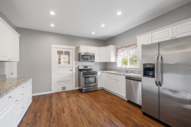 610 Clinton St, Lockport, IL 60441 - kitchen featuring stainless steel appliances, a sink, light stone countertops, white cabinetry, and dark wood-style flooring