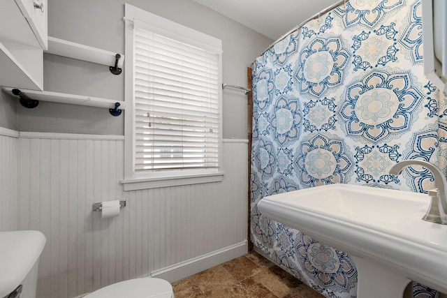 610 Clinton St, Lockport, IL 60441 - bathroom featuring toilet, wainscoting, baseboards, and a sink