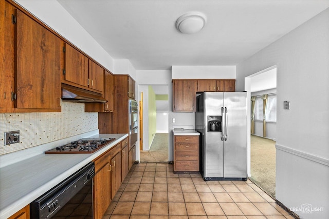 6406 Marshall Dr, Woodridge, IL 60517 - kitchen with stainless steel appliances, light countertops, tasteful backsplash, under cabinet range hood, and brown cabinets