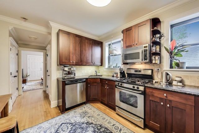 2336 W Roscoe St Unit 3R, Chicago, IL 60618 - kitchen with stainless steel appliances, light wood-style floors, open shelves, tasteful backsplash, and crown molding