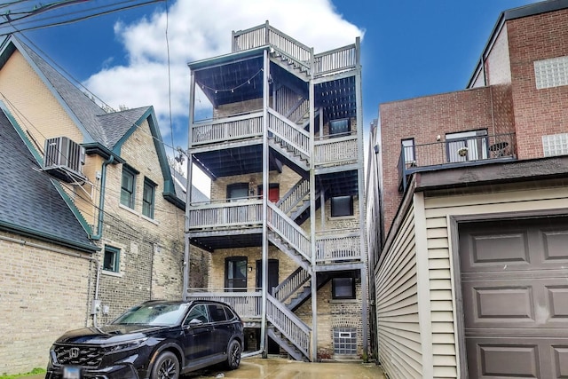 2336 W Roscoe St Unit 3R, Chicago, IL 60618 - view of property with stairway and a garage
