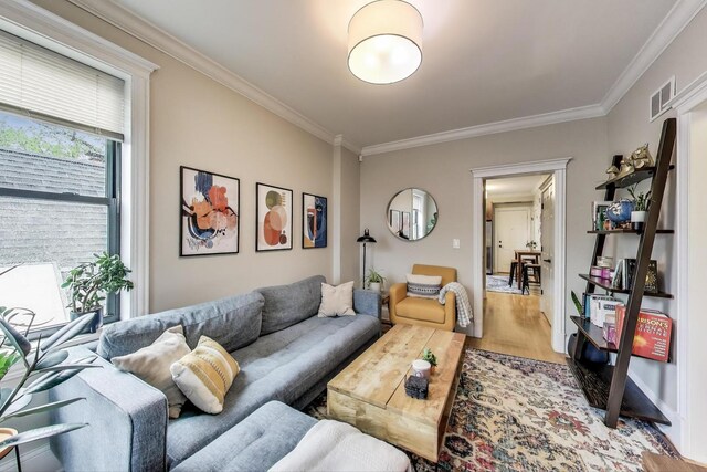 2336 W Roscoe St Unit 3R, Chicago, IL 60618 - living area with ornamental molding and light wood-style floors
