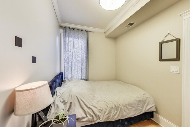 2336 W Roscoe St Unit 3R, Chicago, IL 60618 - bedroom featuring crown molding, baseboards, and wood finished floors