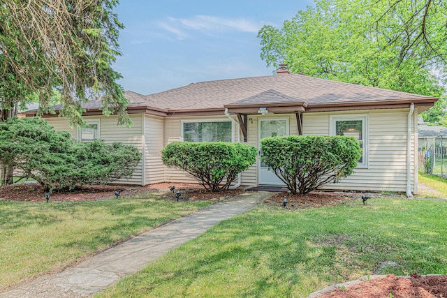 2315 Gilboa Ave, Zion, IL 60099 - bungalow-style house with a front lawn, a chimney, and a shingled roof