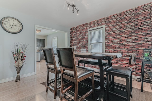 2315 Gilboa Ave, Zion, IL 60099 - dining space featuring brick wall and light wood-style floors