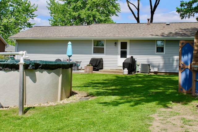 818 Edwin Dr, Bourbonnais, IL 60914 - rear view of house featuring a lawn, cooling unit, and roof with shingles