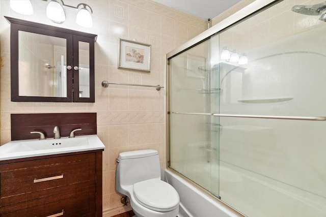 366 Meadow Ct Unit 366, Vernon Hills, IL 60061 - bathroom with tile walls, toilet, vanity, and enclosed tub / shower combo