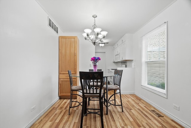 366 Meadow Ct Unit 366, Vernon Hills, IL 60061 - dining space featuring a chandelier, ornamental molding, light wood-style floors, and baseboards