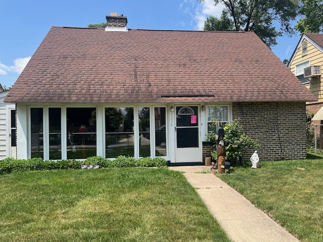4234 Prescott Ave, Lyons, IL 60534 - cape cod-style house with roof with shingles, a front lawn, a chimney, and brick siding