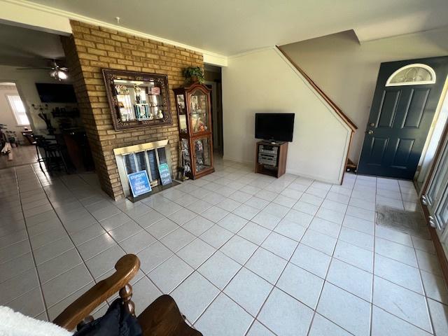 4234 Prescott Ave, Lyons, IL 60534 - living room featuring a ceiling fan, light tile patterned floors, and a fireplace