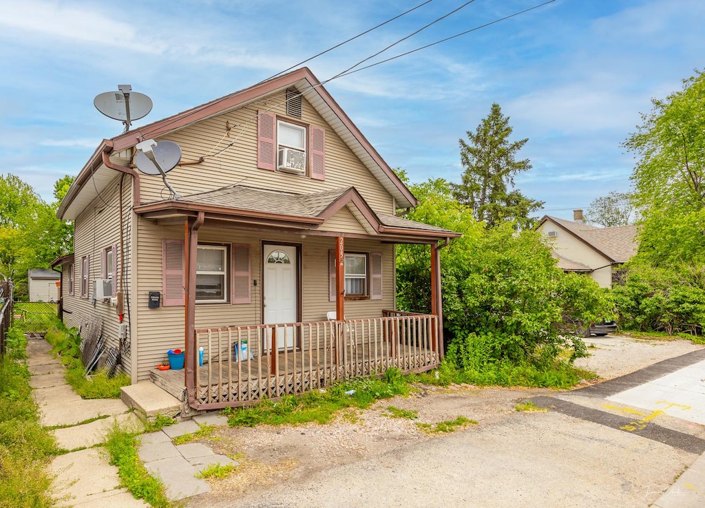 view of front of house with a porch and cooling unit