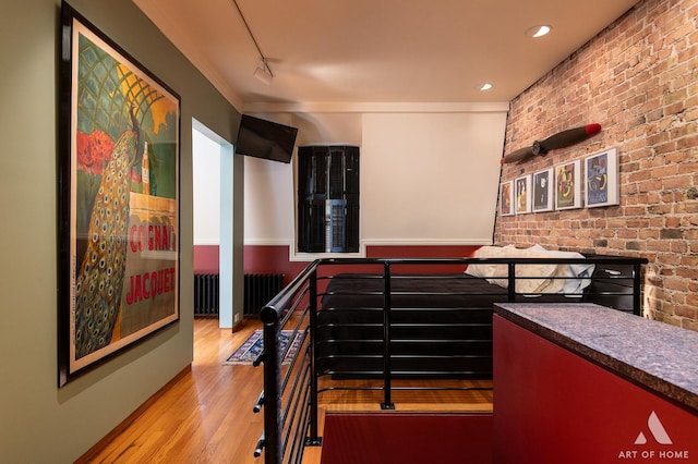 11333 S Langley Ave, Chicago, IL 60628 - hallway with wood finished floors, brick wall, and radiator