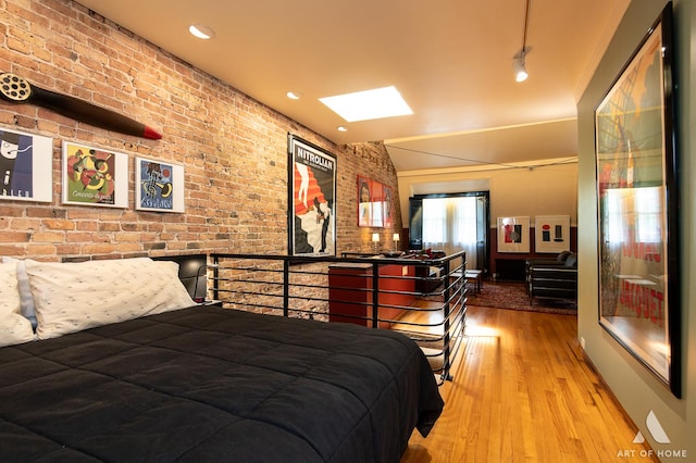 11333 S Langley Ave, Chicago, IL 60628 - bedroom with brick wall, wood finished floors, and recessed lighting