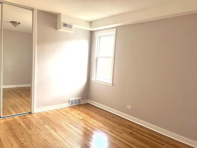 9109 Lamon Ave Unit 2N, Skokie, IL 60077 - empty room featuring wood finished floors and baseboards
