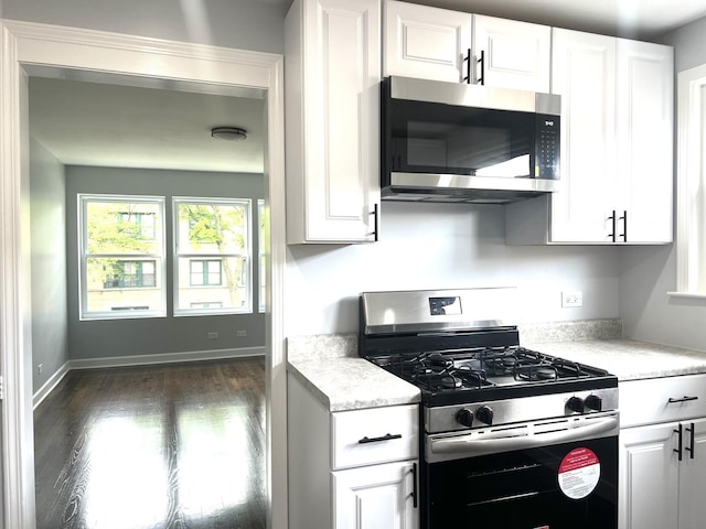 9109 Lamon Ave Unit 2N, Skokie, IL 60077 - kitchen featuring stainless steel appliances, dark wood-type flooring, and white cabinetry