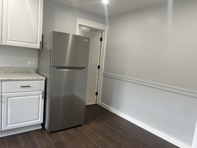 9109 Lamon Ave Unit 2N, Skokie, IL 60077 - kitchen with freestanding refrigerator, dark wood-style flooring, and white cabinets