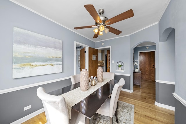 213 N Marion St Unit 2D, Oak Park, IL 60302 - dining area with arched walkways, wood finished floors, baseboards, ceiling fan, and ornamental molding