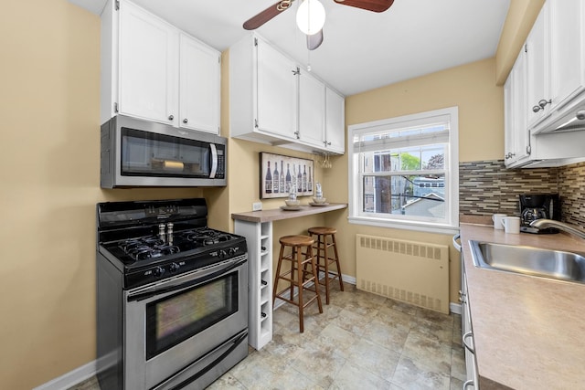 213 N Marion St Unit 2D, Oak Park, IL 60302 - kitchen featuring stainless steel appliances, radiator heating unit, a sink, ceiling fan, and white cabinets