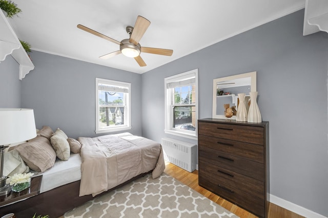 213 N Marion St Unit 2D, Oak Park, IL 60302 - bedroom with radiator, light wood finished floors, crown molding, a ceiling fan, and baseboards