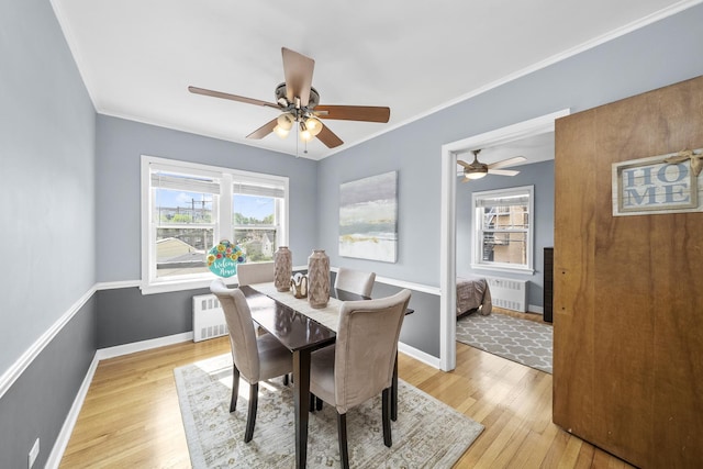 213 N Marion St Unit 2D, Oak Park, IL 60302 - dining area with radiator, light wood-style floors, ceiling fan, crown molding, and baseboards