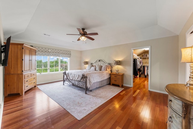 13187 Briar Patch Ln, Lemont, IL 60439 - bedroom with hardwood / wood-style flooring, a walk in closet, baseboards, vaulted ceiling, and ceiling fan