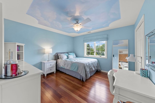 13187 Briar Patch Ln, Lemont, IL 60439 - bedroom featuring dark wood-style flooring, a ceiling fan, baseboards, and a raised ceiling