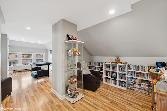 sitting room featuring vaulted ceiling, wood finished floors, baseboards, a baseboard heating unit, and recessed lighting