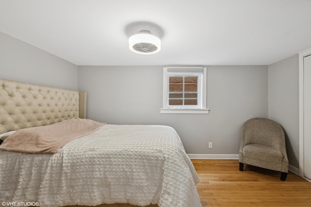 bedroom featuring wood finished floors and baseboards