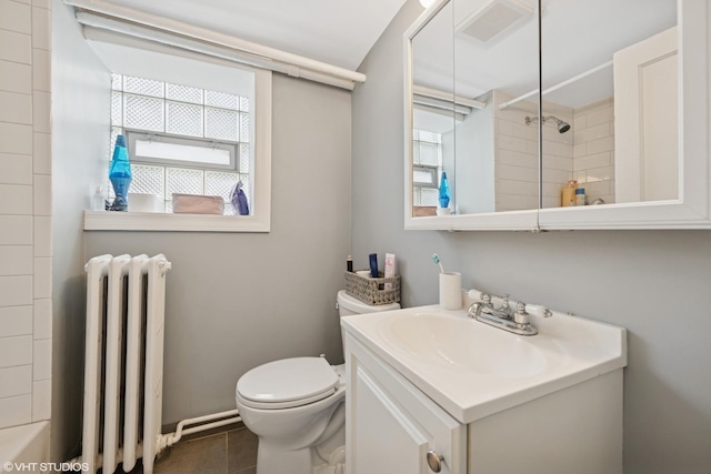 full bath featuring radiator, a shower, toilet, vanity, and tile patterned flooring