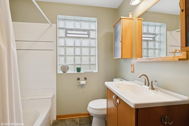 full bathroom with toilet, healthy amount of natural light, baseboards, and vanity